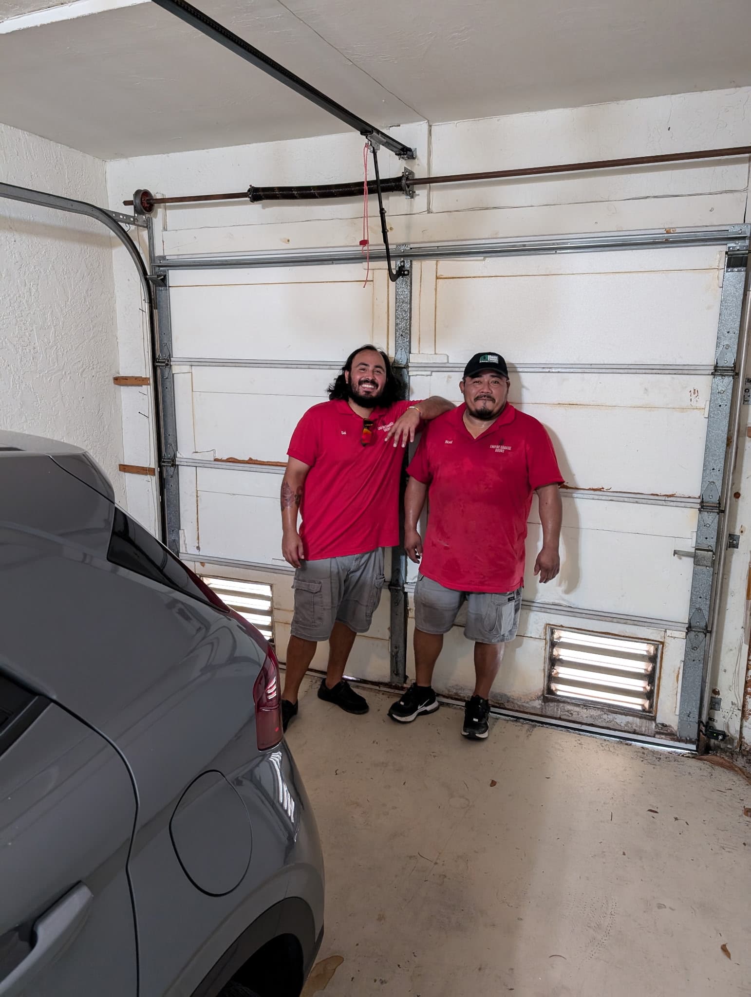Empire Garage Doors technician inspecting a residential garage door